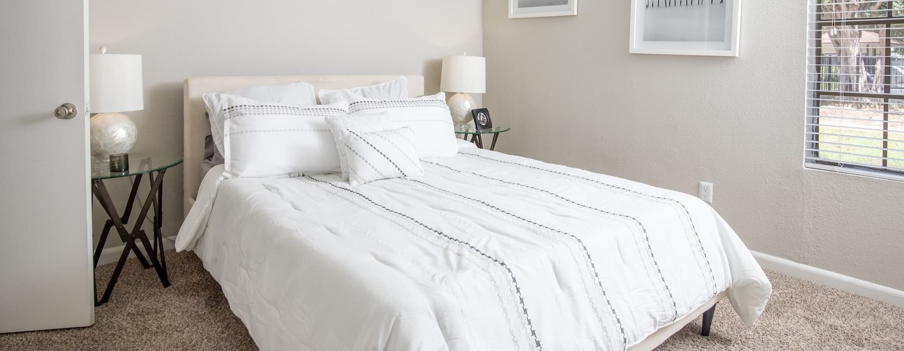 bedroom with ample space around the bed and bright lighting