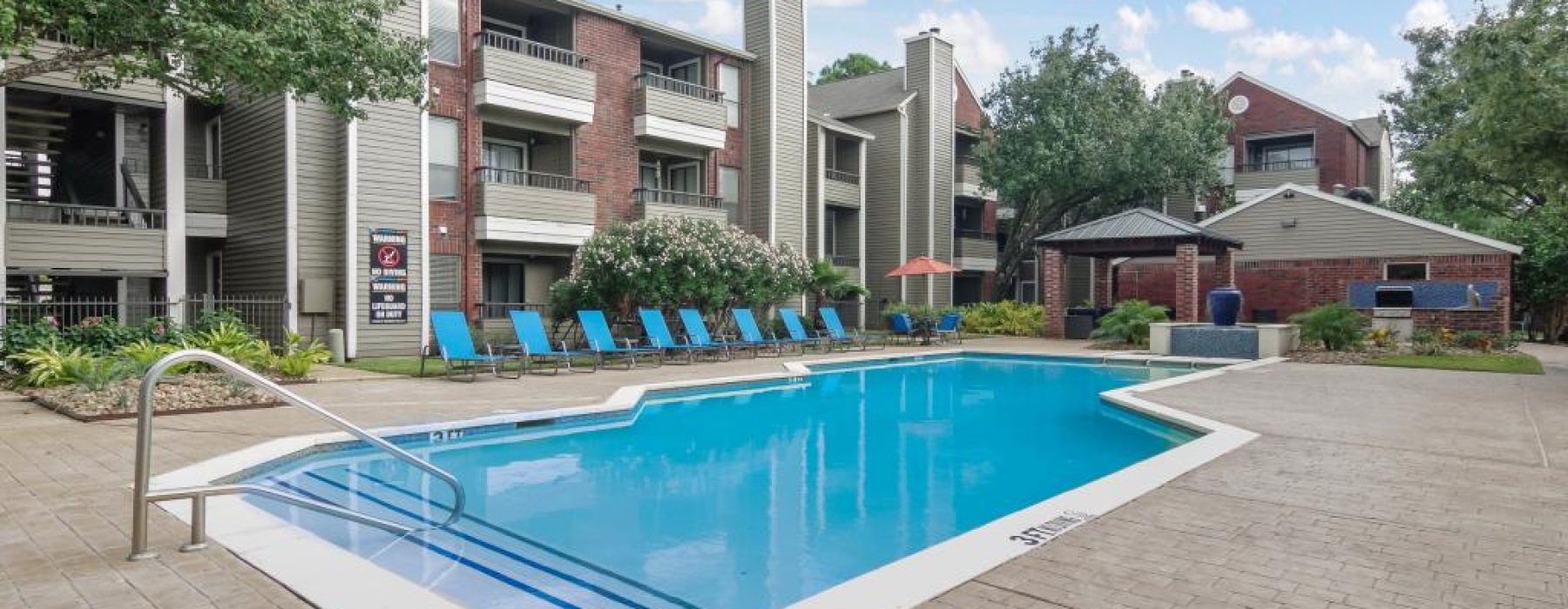 Resort-style swimming pool with lounge seating